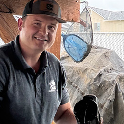 A Stack Service Plumbing employee smiling while working on a job